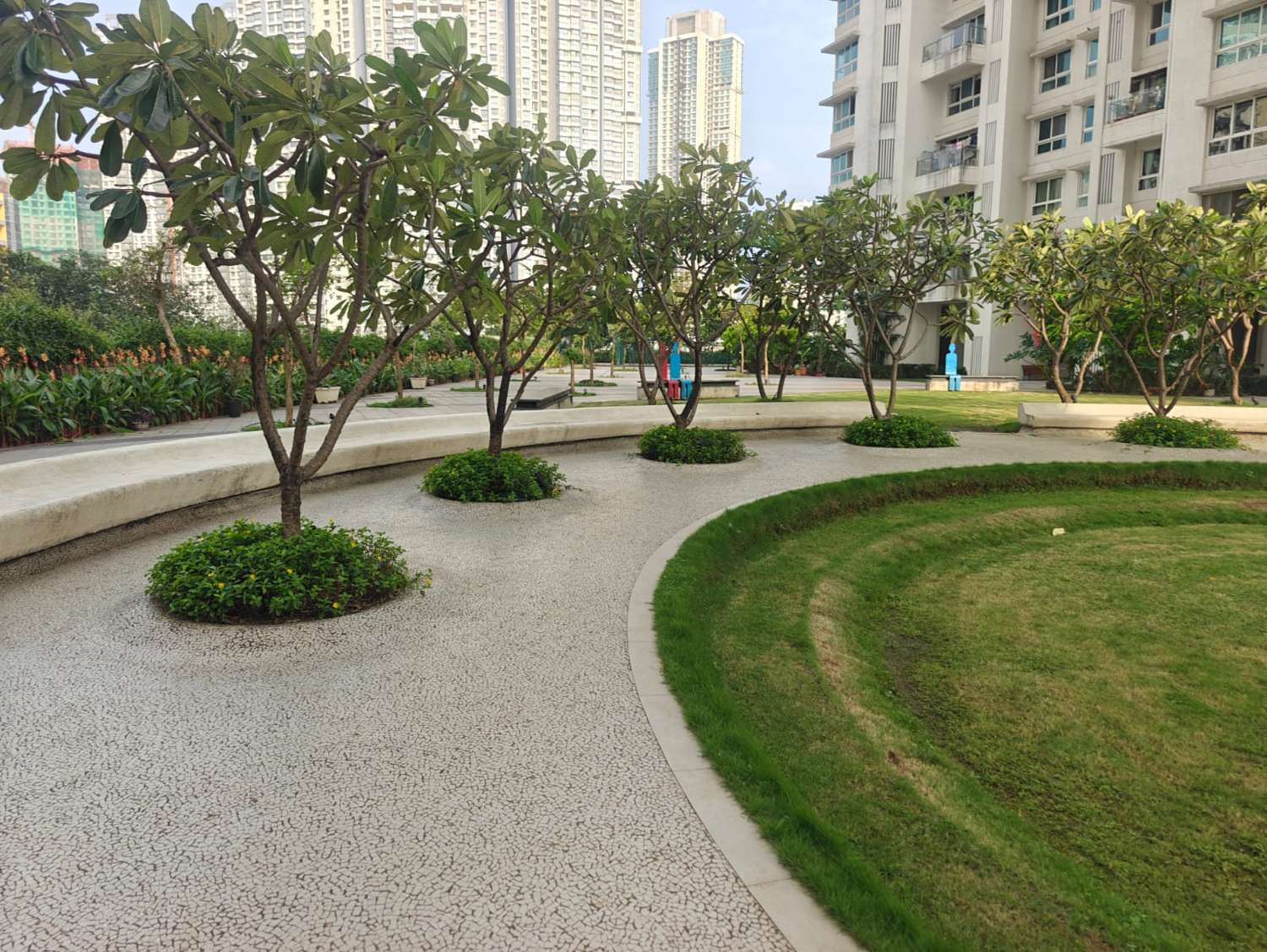 Landscaped courtyard with frangipani trees and lawn
